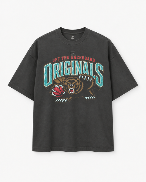 A dark gray washed graphic t-shirt featuring a stylized grizzly bear mascot holding a football, with the text 'OFF THE BACKBOARD ORIGINS' in teal and red.