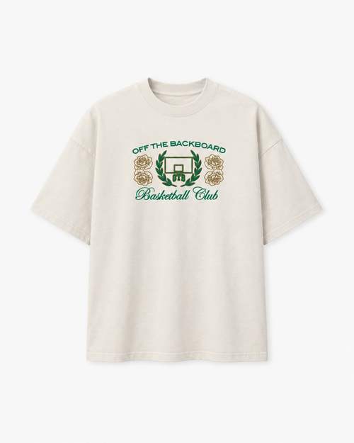 An off-white short-sleeve t-shirt with a green and gold graphic on the chest reading 'OFF THE BACKBOARD Basketball Club' with a basketball hoop and roses.
