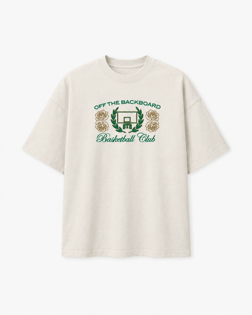 An off-white short-sleeve t-shirt with a green and gold graphic on the chest reading 'OFF THE BACKBOARD Basketball Club' with a basketball hoop and roses.