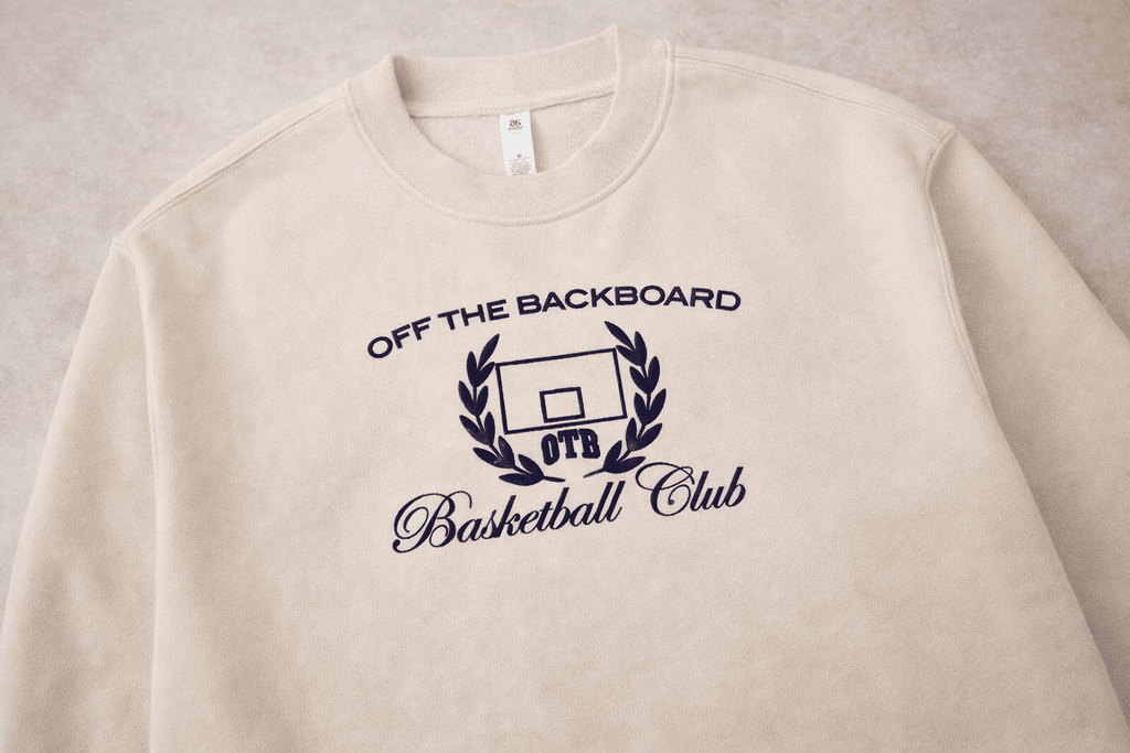 Beige sweatshirt with 'Off The Backboard Basketball Club' logo on a beige background