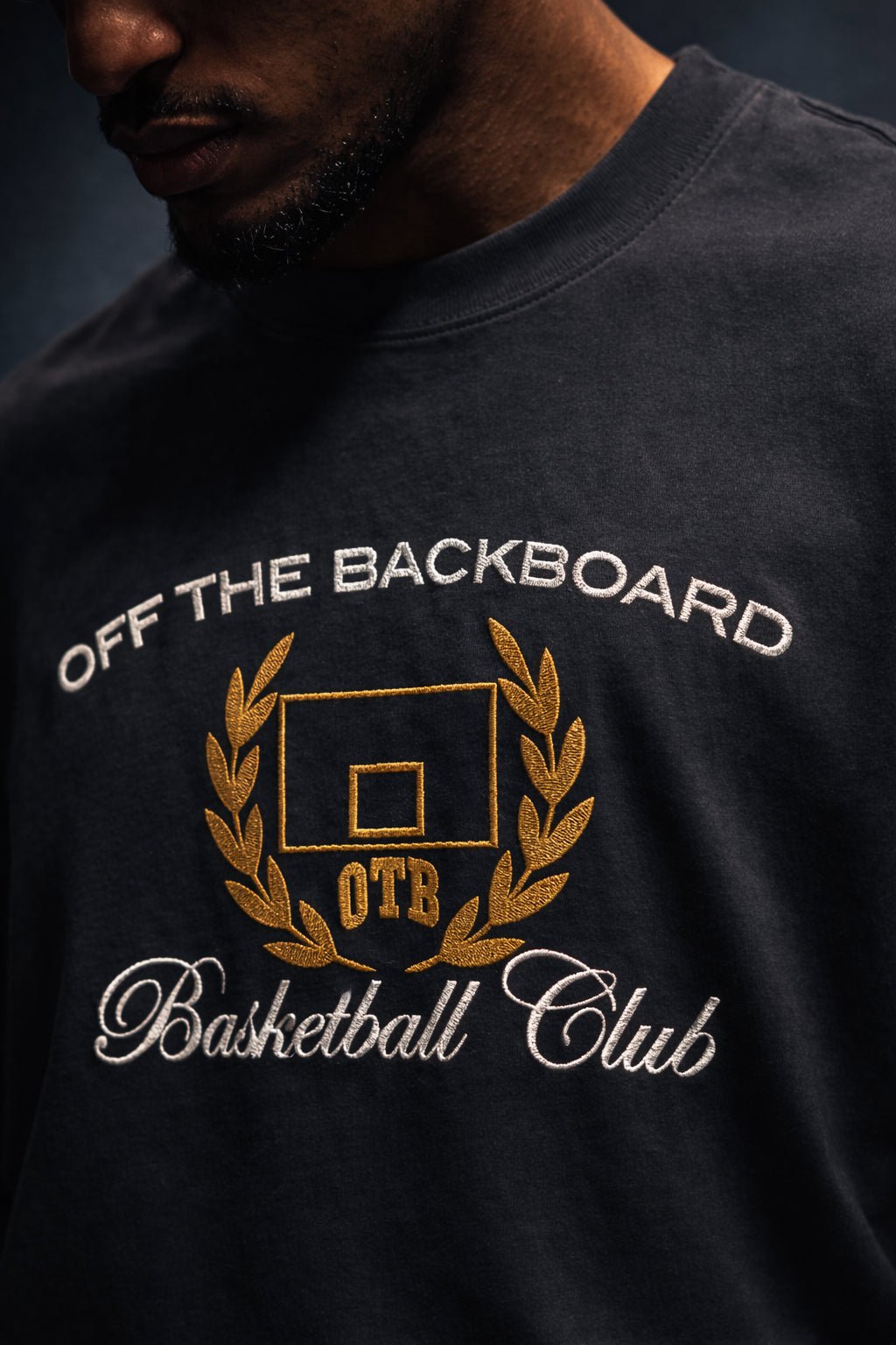 Black t-shirt with 'Off The Backboard Basketball Club' text and logo on a dark background