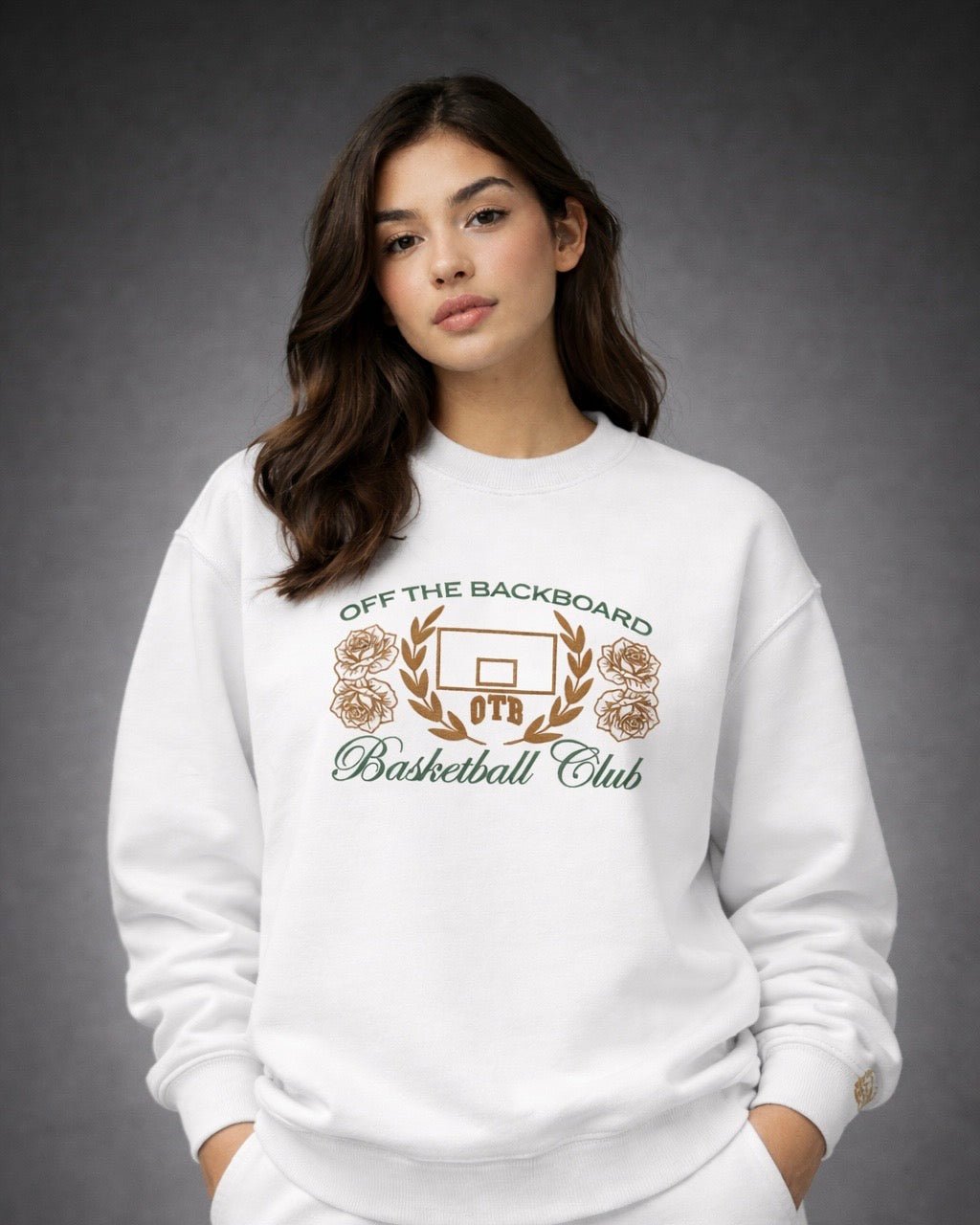 Woman wearing a white sweatshirt with 'Off the Backboard Basketball Club' logo on a gray background