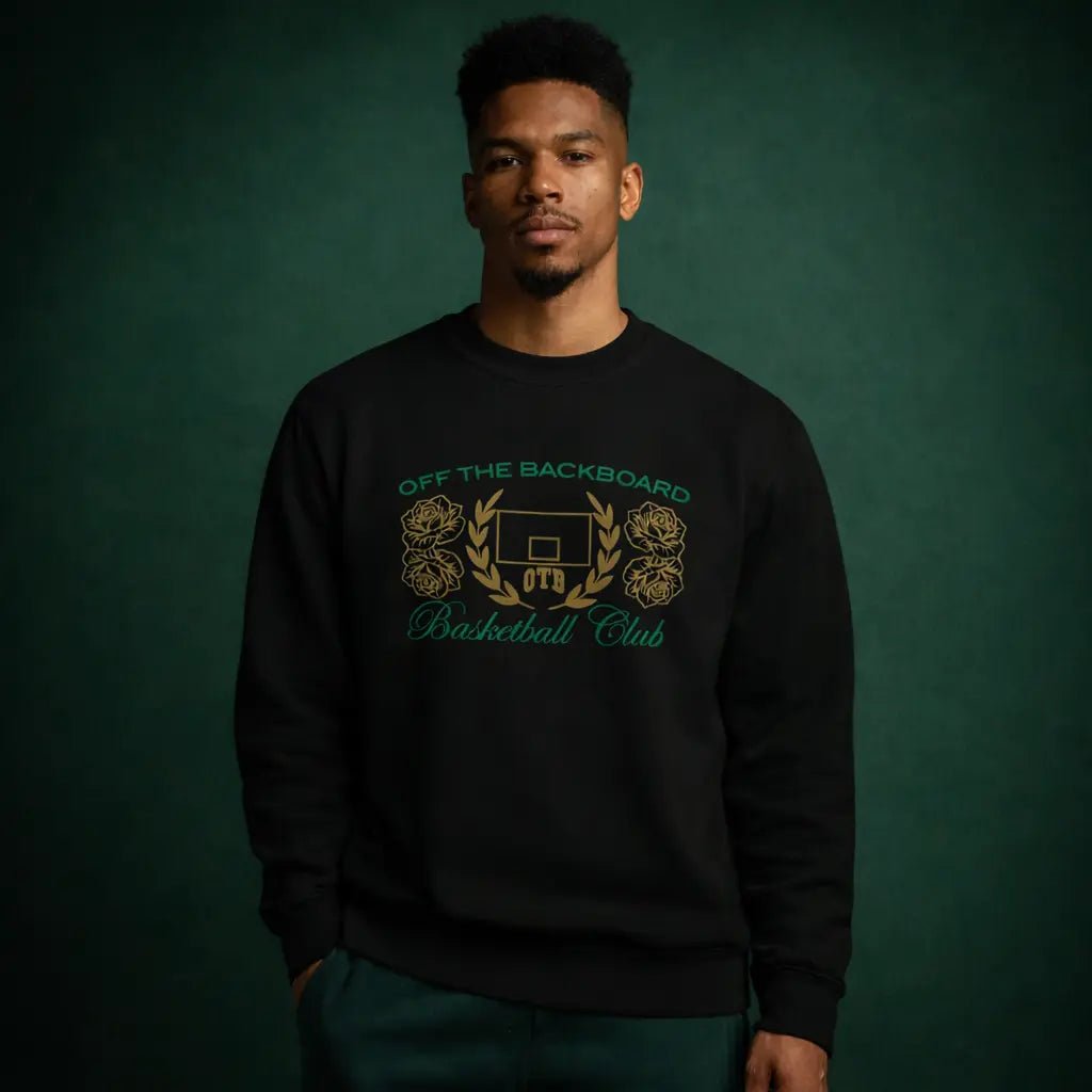 Man wearing a black sweatshirt with 'Off the Backboard Basketball Club' design on a dark green background