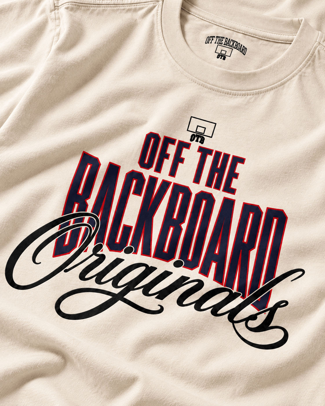 Close-up of an off-white crewneck t-shirt featuring a graphic print that reads 'OFF THE BACKBOARD Originals' in bold red and black lettering, with a small basketball hoop icon above the text.